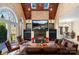 Living room features a stone fireplace, vaulted ceiling, a bar area, and ample natural light at 5752 Natoma Rd, Lake Wylie, SC 29710
