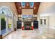 Sunroom features stone fireplace and wall of windows at 5752 Natoma Rd, Lake Wylie, SC 29710