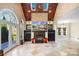 Sunroom with stone fireplace, vaulted ceiling and access to deck at 5752 Natoma Rd, Lake Wylie, SC 29710