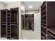 Spacious walk-in closet with custom built-ins and mirrored doors at 5752 Natoma Rd, Lake Wylie, SC 29710