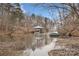 Scenic waterfront view with a covered boat dock, small boats, and beautiful natural surroundings at 5752 Natoma Rd, Lake Wylie, SC 29710