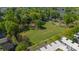 An aerial view showcasing the neighborhood, large green space, and surrounding tree coverage at 947 Warren Burgess Ln, Charlotte, NC 28205