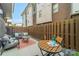 Cozy backyard with patio seating, privacy fence, and string lights at 947 Warren Burgess Ln, Charlotte, NC 28205