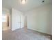 Bedroom featuring a closet, neutral carpet, and access to bathroom at 947 Warren Burgess Ln, Charlotte, NC 28205