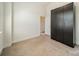 Bright bedroom featuring tan carpet floors and a large closet with modern silver hardware at 947 Warren Burgess Ln, Charlotte, NC 28205