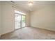 Bright bedroom with sliding glass doors and neutral carpet at 947 Warren Burgess Ln, Charlotte, NC 28205