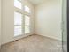 Bright bedroom features light walls, carpet flooring, and bright natural light from large windows at 947 Warren Burgess Ln, Charlotte, NC 28205
