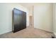 Bright bedroom featuring tan carpet floors and a large closet with modern silver hardware at 947 Warren Burgess Ln, Charlotte, NC 28205