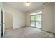 Bright bedroom features balcony access and neutral carpet at 947 Warren Burgess Ln, Charlotte, NC 28205