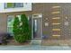 Charming brick townhome with a private front entrance and a well-maintained landscaped garden at 947 Warren Burgess Ln, Charlotte, NC 28205