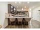 Kitchen with stone countertops, pendant lighting, and barstool seating at the island at 947 Warren Burgess Ln, Charlotte, NC 28205