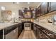 Beautiful kitchen showcasing dark cabinets, stone countertops, and stainless steel appliances at 947 Warren Burgess Ln, Charlotte, NC 28205