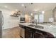 Well-lit kitchen with a granite-top island, modern appliances, and hardwood flooring at 947 Warren Burgess Ln, Charlotte, NC 28205