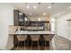 Spacious kitchen island with barstool seating, granite countertops, and stainless appliances at 947 Warren Burgess Ln, Charlotte, NC 28205