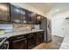 Elegant kitchen with stainless steel refrigerator, dark cabinets, and granite countertops at 947 Warren Burgess Ln, Charlotte, NC 28205