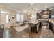 Bright living room featuring an open layout, hardwood floors, and modern kitchen with granite counters at 947 Warren Burgess Ln, Charlotte, NC 28205