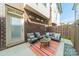 Private brick patio features an outdoor seating area with a stylish rug and comfortable furniture at 947 Warren Burgess Ln, Charlotte, NC 28205