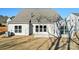 Back of house with small patio, freshly seeded yard, and view of neighborhood house at 1065 Kinship Dr # 080, Lancaster, SC 29720