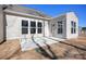 Back of house with small patio, freshly seeded yard, and view of neighborhood at 1065 Kinship Dr # 080, Lancaster, SC 29720
