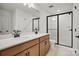 Bathroom with double vanity, white countertops, and glass-enclosed shower with white subway tile at 1065 Kinship Dr # 080, Lancaster, SC 29720