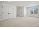 Bright, carpeted bedroom features double closets and a window with natural light at 1065 Kinship Dr # 080, Lancaster, SC 29720