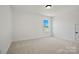 Bright bedroom with neutral carpet, white walls, and a window showcasing the outdoors at 1065 Kinship Dr # 080, Lancaster, SC 29720