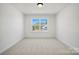 Bedroom featuring carpet flooring, white walls, white trim and a large window at 1065 Kinship Dr # 080, Lancaster, SC 29720