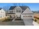 Charming two-story home with a welcoming entrance, landscaped yard, and attached two-car garage at 1065 Kinship Dr # 080, Lancaster, SC 29720