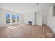 Living room featuring ample natural light, brick fireplace, and wood floors at 1065 Kinship Dr # 080, Lancaster, SC 29720