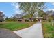 Ranch style home with a long driveway and mature trees at 130 Island Park Ln, Statesville, NC 28625