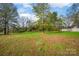 Large backyard with grassy area and mature trees at 130 Island Park Ln, Statesville, NC 28625