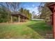 Spacious backyard with grassy area and covered storage structure at 130 Island Park Ln, Statesville, NC 28625