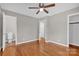 Bright bedroom with hardwood floors, ceiling fan, and private bathroom access at 130 Island Park Ln, Statesville, NC 28625