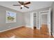 Bedroom with hardwood floors, ceiling fan and access to another room at 130 Island Park Ln, Statesville, NC 28625