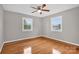 Well-lit bedroom featuring hardwood floors and ceiling fan at 130 Island Park Ln, Statesville, NC 28625
