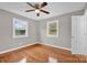 Bedroom with hardwood floors, ceiling fan and two windows at 130 Island Park Ln, Statesville, NC 28625