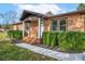 Brick ranch house with landscaped yard and a covered porch at 130 Island Park Ln, Statesville, NC 28625