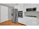 Stainless steel appliances and white shaker cabinets in this kitchen at 130 Island Park Ln, Statesville, NC 28625