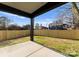 An open back yard features a concrete patio, lawn, and a new wooden fence at 2201 Catalina Ave, Charlotte, NC 28206