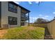 The backyard features new sod, a screen porch, a privacy fence, and shade trees at 2201 Catalina Ave, Charlotte, NC 28206