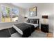Stylish bedroom with a modern bed, matching nightstands, and a large window at 2201 Catalina Ave, Charlotte, NC 28206