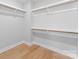 Walk-in closet features plenty of shelving and hardwood floors at 2201 Catalina Ave, Charlotte, NC 28206