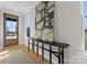 Welcoming entryway with a stylish console table, modern art, and a wood front door at 2201 Catalina Ave, Charlotte, NC 28206