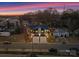 Modern duplex with individual driveways, garages, and stylish black and white exterior under a colorful sunset at 2201 Catalina Ave, Charlotte, NC 28206