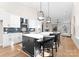 Modern kitchen with white cabinets, dark island with bar stool seating, and stainless steel appliances at 2201 Catalina Ave, Charlotte, NC 28206