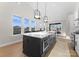 Bright kitchen boasts a large island with modern appliances, stylish pendant lighting and lots of natural light at 2201 Catalina Ave, Charlotte, NC 28206