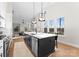 Open kitchen with large island, pendant lighting, and stainless steel appliances provides an ideal entertaining space at 2201 Catalina Ave, Charlotte, NC 28206