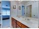 Neat bathroom with a double sink vanity, large mirror, and access to bedroom and shower at 3848 Burnage Hall Rd, Harrisburg, NC 28075