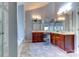 Elegant bathroom featuring double sinks, wooden cabinetry, mirrors, and a separate bathtub at 3848 Burnage Hall Rd, Harrisburg, NC 28075