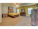 Bright bedroom with a yellow accent wall, complemented by a bed, dresser, and natural light at 3848 Burnage Hall Rd, Harrisburg, NC 28075